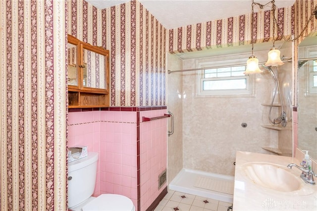 bathroom with toilet, walk in shower, tile patterned flooring, and vanity