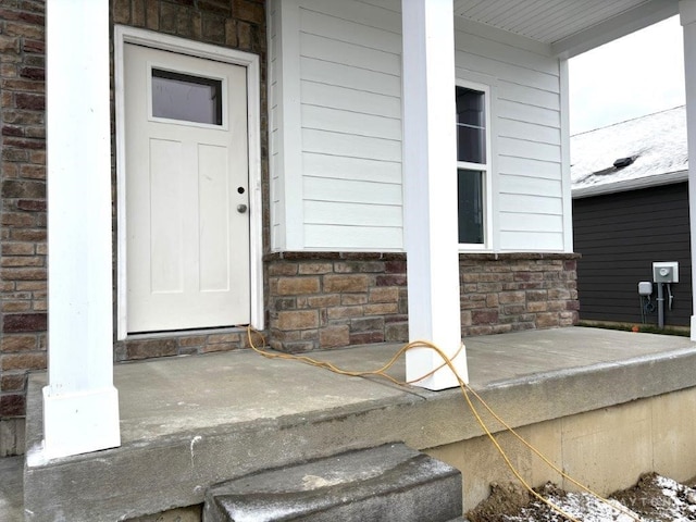 entrance to property featuring covered porch