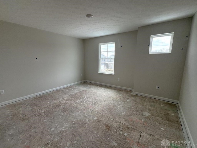 empty room with a textured ceiling