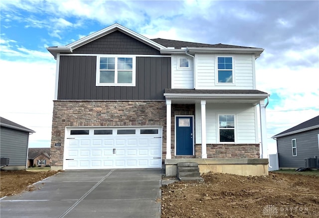 view of front of home featuring a garage and central air condition unit