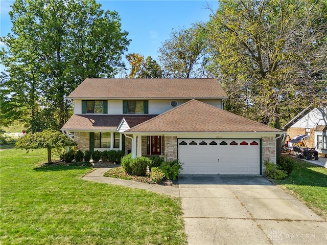 view of property with a garage and a front lawn