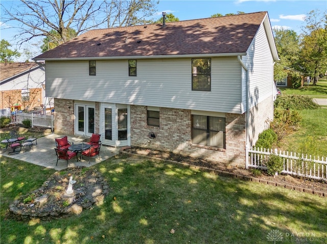 rear view of property featuring a yard and a patio