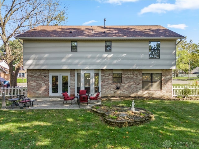 back of house featuring a yard and a patio area