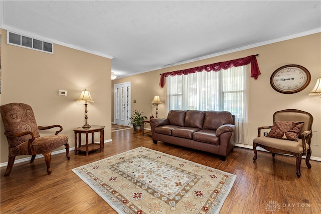 living room featuring dark hardwood / wood-style floors and ornamental molding