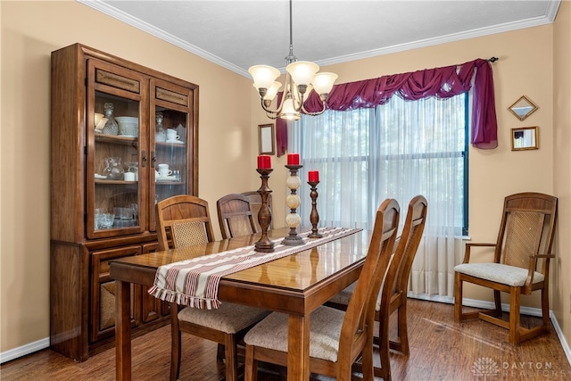 dining space with a chandelier, dark hardwood / wood-style flooring, and ornamental molding