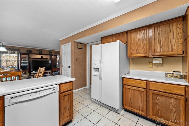 kitchen with light tile patterned floors, white appliances, and ornamental molding