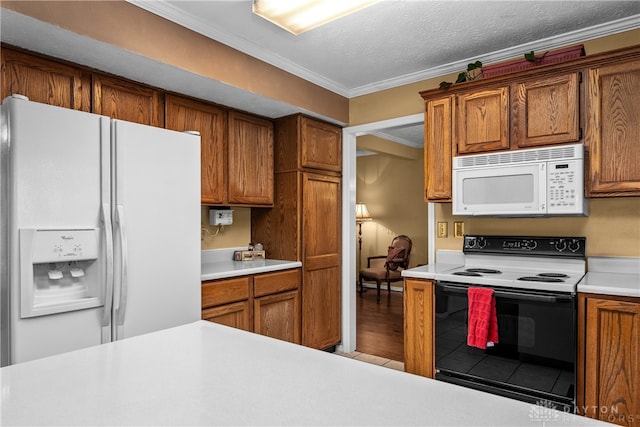 kitchen with a textured ceiling, white appliances, hardwood / wood-style flooring, and crown molding