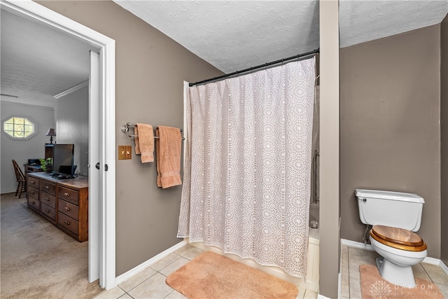 bathroom with toilet, shower / tub combo, a textured ceiling, and tile patterned floors