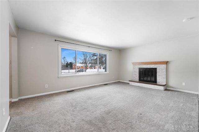 unfurnished living room with carpet flooring and a fireplace