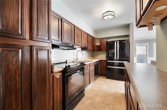 kitchen featuring sink, black appliances, and dark brown cabinets