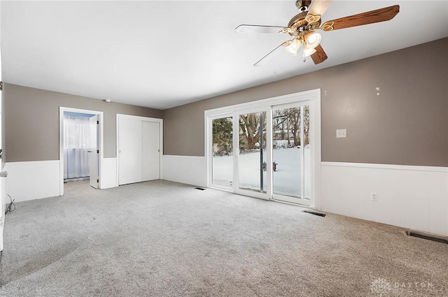 empty room with light colored carpet and ceiling fan