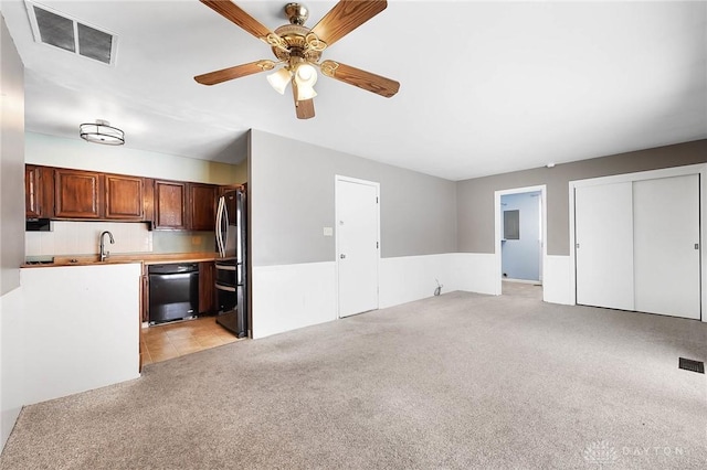 unfurnished living room featuring ceiling fan, sink, and light colored carpet