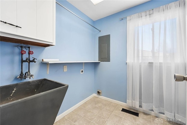 laundry room with hookup for an electric dryer, cabinets, sink, electric panel, and light tile patterned flooring