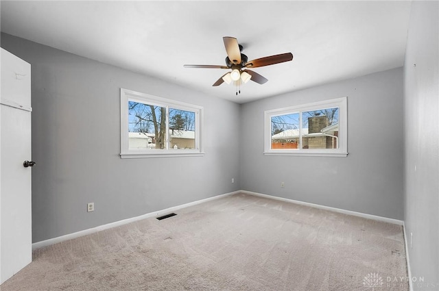 carpeted empty room featuring ceiling fan