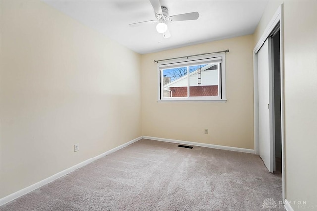 unfurnished bedroom with ceiling fan, a closet, and light carpet