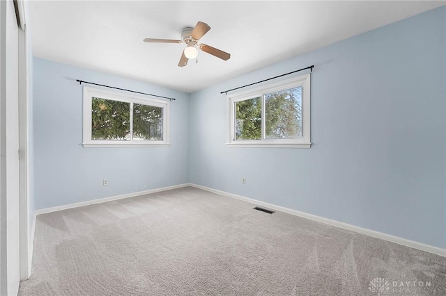 spare room with light colored carpet and ceiling fan