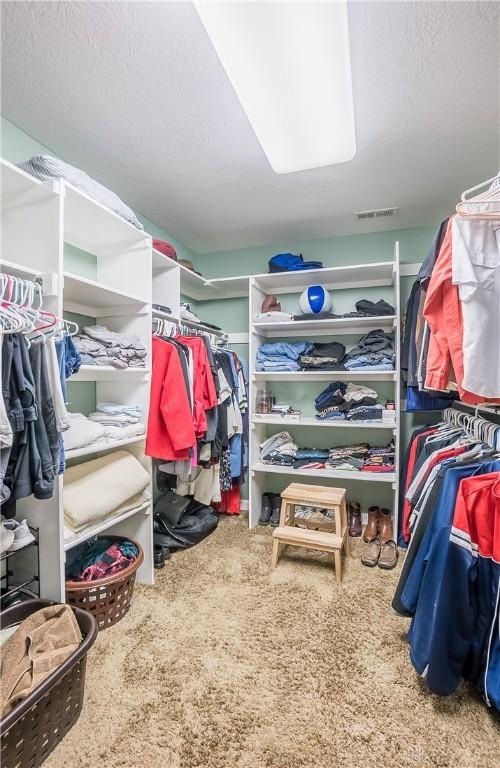 walk in closet with visible vents