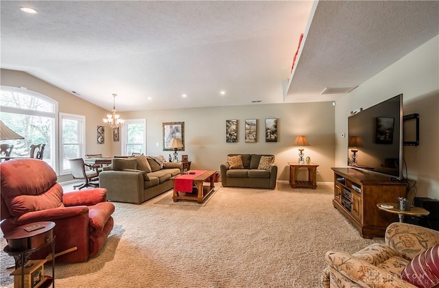 living room featuring visible vents, light carpet, a notable chandelier, a textured ceiling, and vaulted ceiling