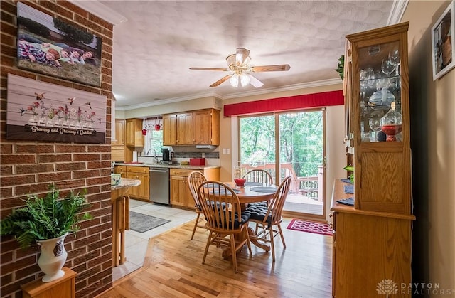 dining area with crown molding, ceiling fan, sink, and light hardwood / wood-style floors