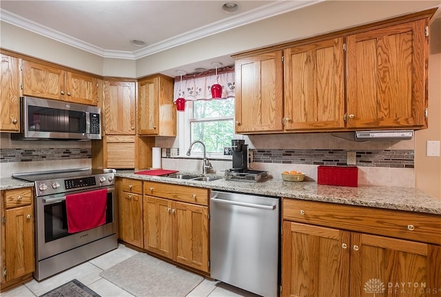 kitchen with light stone counters, stainless steel appliances, crown molding, and sink