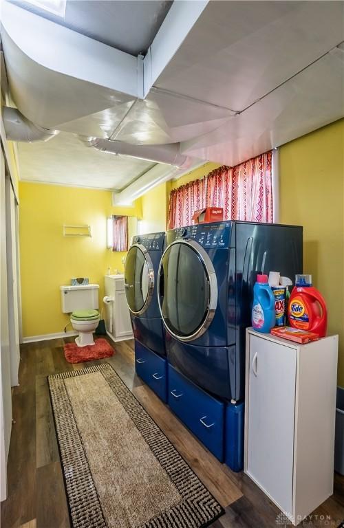 laundry room with washing machine and dryer and dark hardwood / wood-style floors