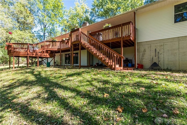 back of house with stairway, a lawn, and a wooden deck