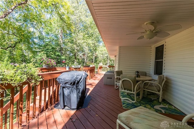 wooden terrace featuring a grill and ceiling fan