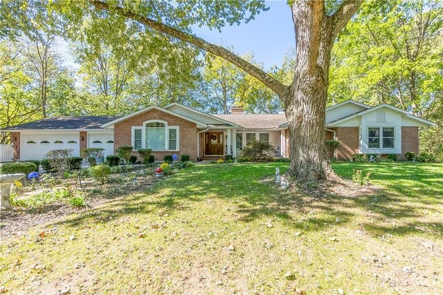 ranch-style house featuring a garage and a front lawn