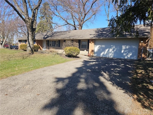 single story home featuring a garage and a front yard