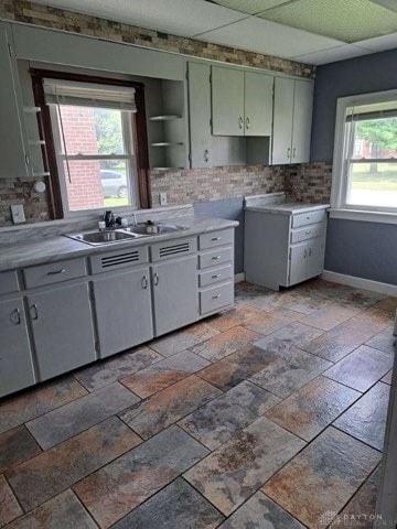 kitchen featuring plenty of natural light, sink, and tasteful backsplash