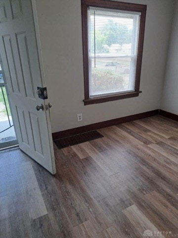 empty room with dark hardwood / wood-style floors