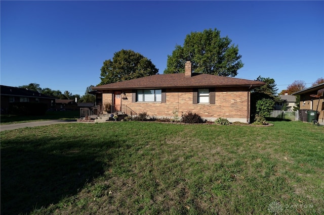 rear view of property with a lawn