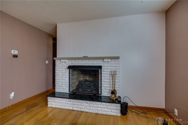 interior details with a fireplace and wood-type flooring