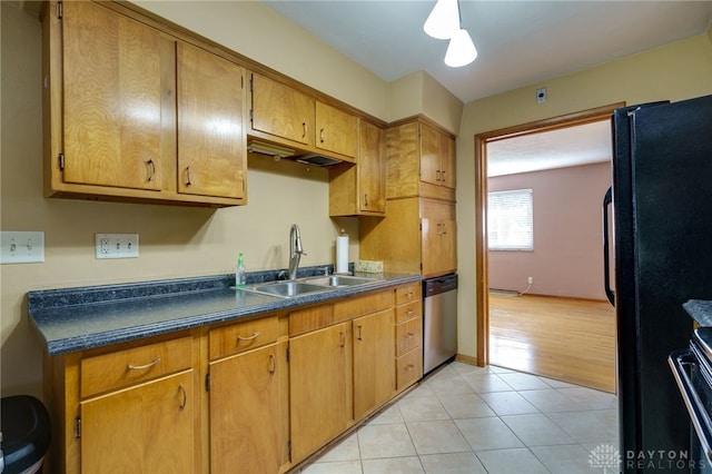 kitchen with dishwasher, black fridge, electric stove, sink, and light hardwood / wood-style floors