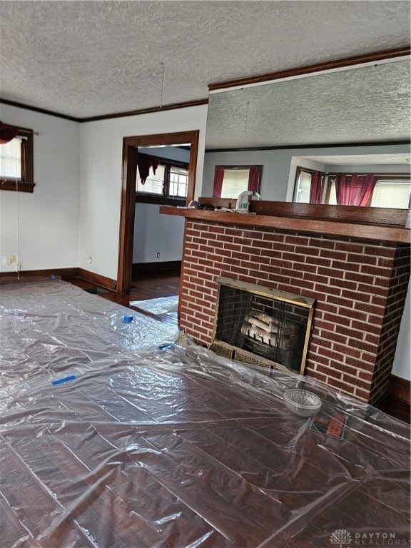 unfurnished living room featuring a textured ceiling and a fireplace