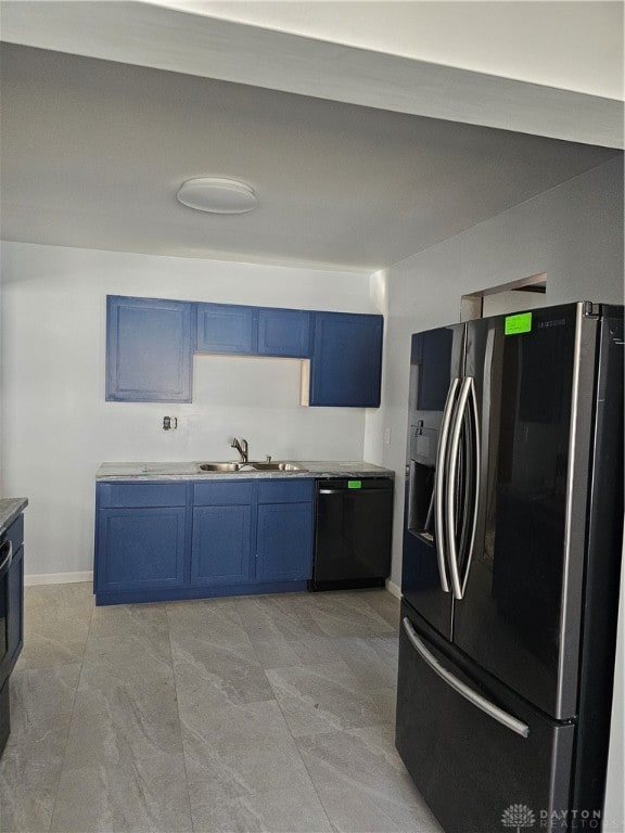 kitchen with dishwasher, blue cabinets, stainless steel fridge, and sink