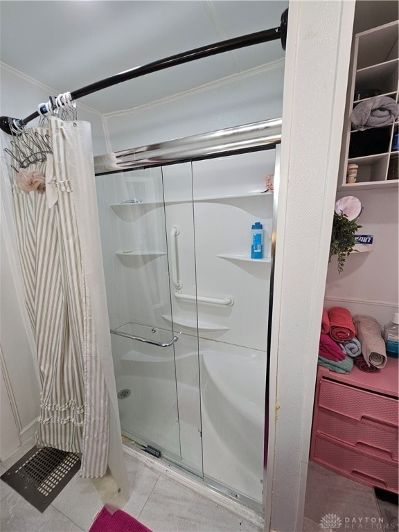 bathroom featuring ornamental molding and curtained shower