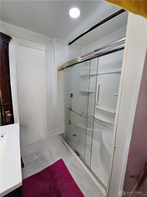 bathroom with vanity and a shower with shower door