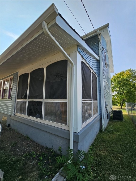 view of side of home featuring a sunroom and central AC unit