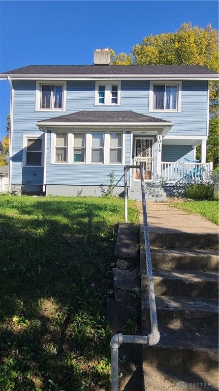 view of front of home with a front lawn and covered porch