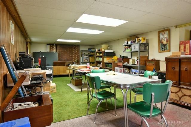 interior space with a paneled ceiling and carpet floors