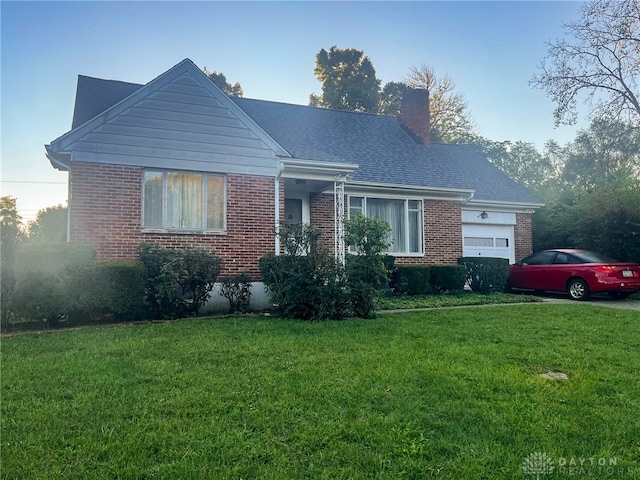 view of front of property with a front lawn and a garage