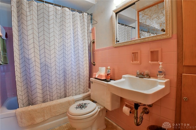 full bathroom featuring tile walls, shower / tub combo, toilet, and sink