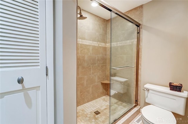 bathroom with toilet and walk in shower