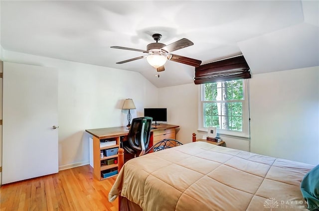 bedroom featuring vaulted ceiling, light wood-type flooring, and ceiling fan