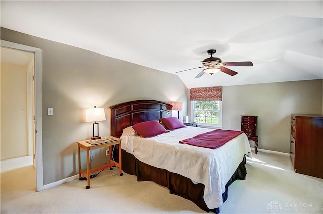 bedroom featuring vaulted ceiling, light carpet, and ceiling fan