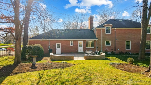 back of house with a yard and a patio