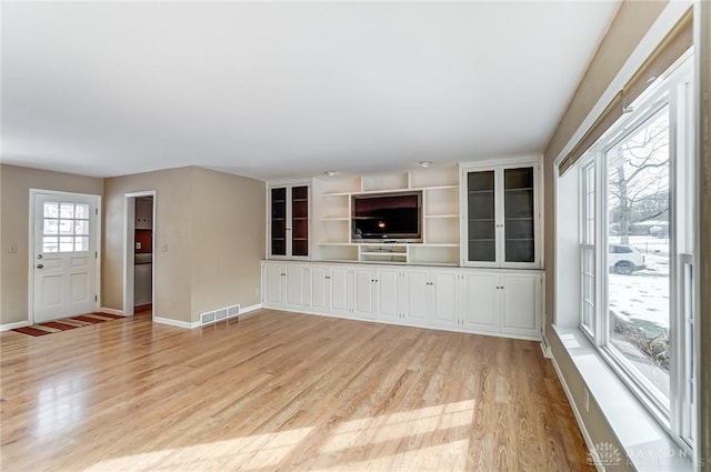 unfurnished living room featuring light wood-type flooring