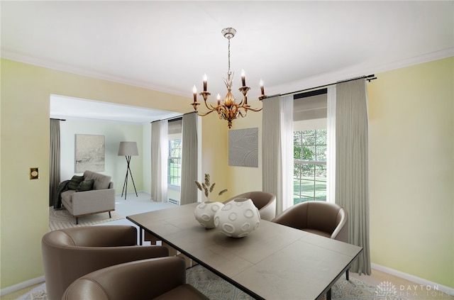 dining room with crown molding, plenty of natural light, light colored carpet, and an inviting chandelier