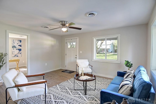 living room with light wood-type flooring and ceiling fan